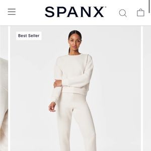 Spanx air essentials sweater in a light pink/dusty rose color.